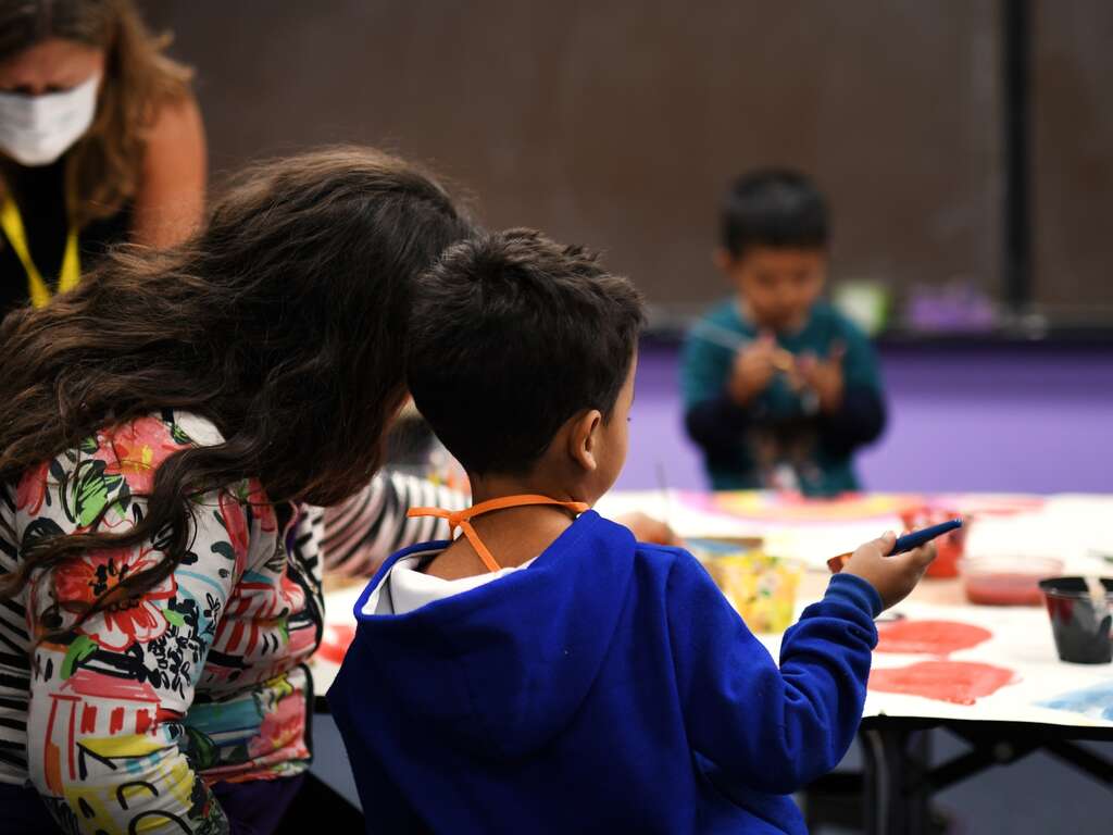 A mother and a son complete an activity together at the IRC welcome center in Phoenix, Arizona.